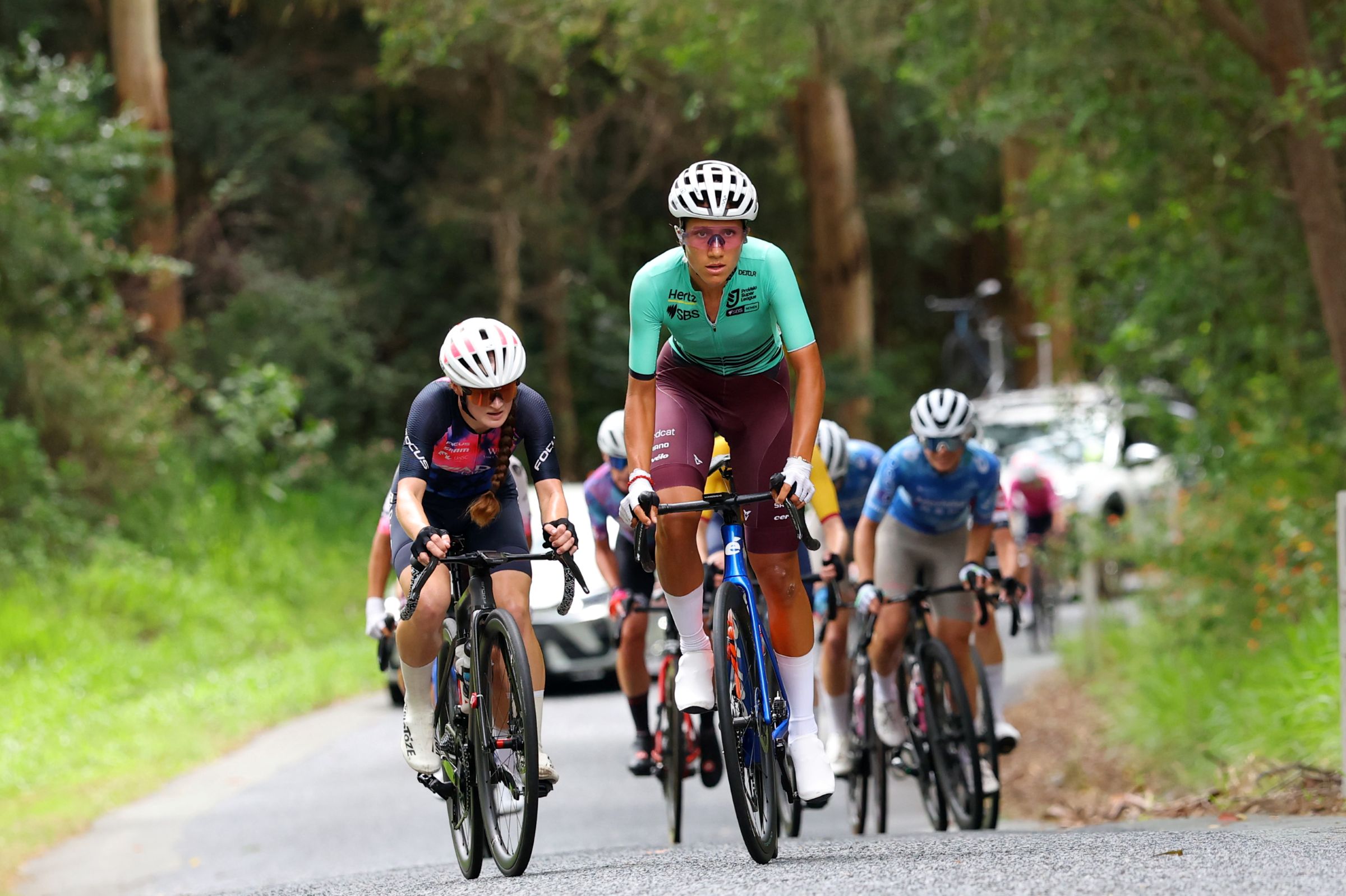 Sophia Sammons climbing in the Q Tour in the PSL ProVelo Super League leader's jersey 2026